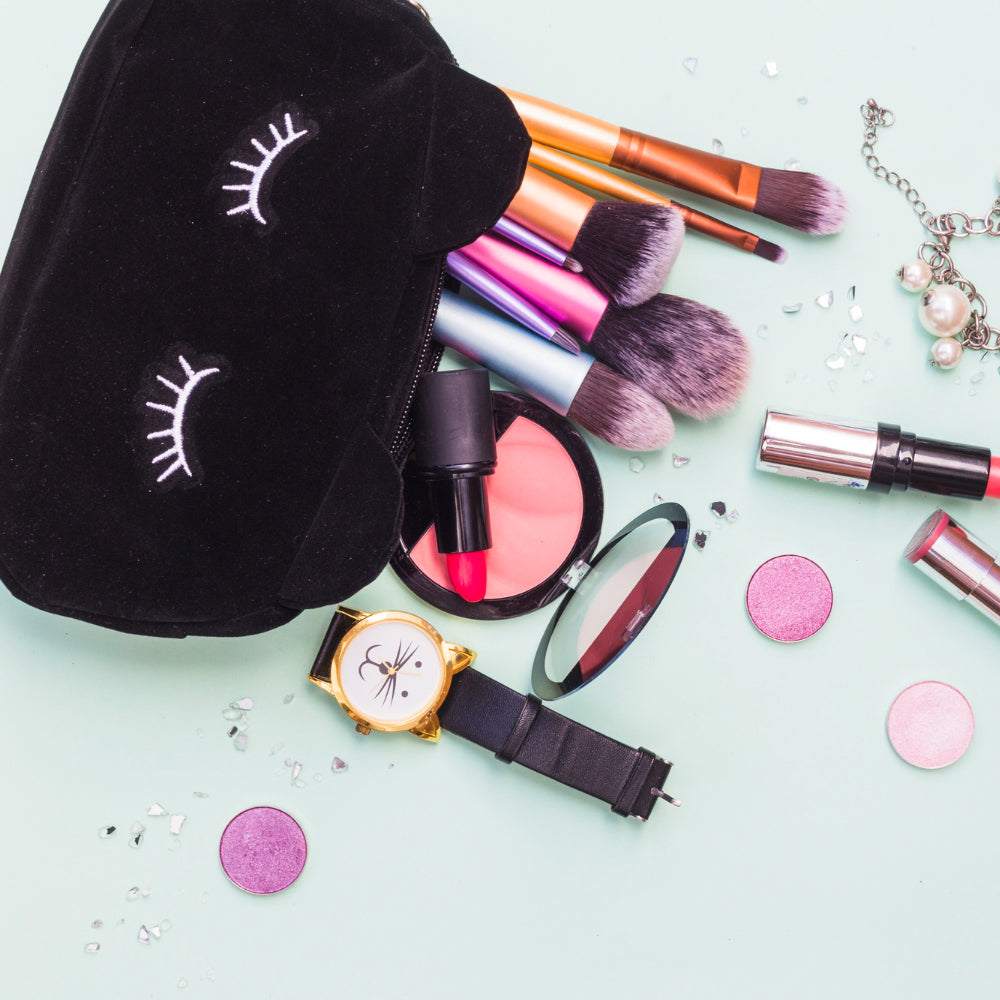 Organizers filled with makeup essentials like brushes, lipsticks, and a cute pouch on a pastel background.